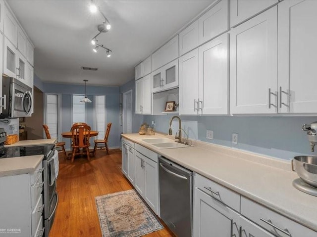 113 Park Blvd, Benton, LA 71006 - kitchen featuring stainless steel appliances, a sink, white cabinets, light countertops, and light wood-style flooring