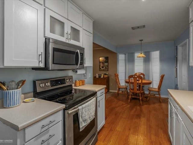 113 Park Blvd, Benton, LA 71006 - kitchen with stainless steel appliances, light wood-style floors, white cabinets, and light countertops