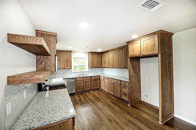 190 Trail Dr, Bowie, TX 76230 - kitchen featuring appliances with stainless steel finishes, a sink, brown cabinets, dark wood-type flooring, and recessed lighting