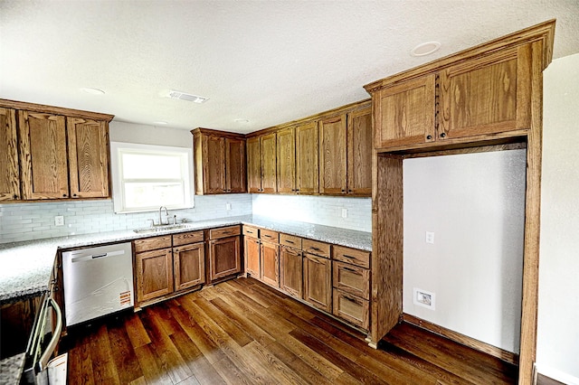 190 Trail Dr, Bowie, TX 76230 - kitchen featuring a sink, dishwasher, dark wood-type flooring, brown cabinetry, and backsplash