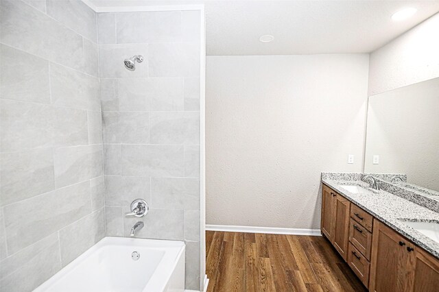 190 Trail Dr, Bowie, TX 76230 - full bath featuring a tub to relax in, wood finished floors, double vanity, baseboards, and a shower