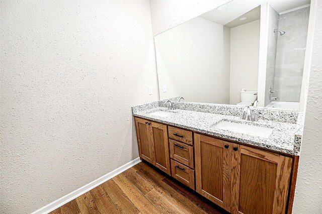 190 Trail Dr, Bowie, TX 76230 - full bath with wood finished floors, double vanity, shower / washtub combination, toilet, and baseboards
