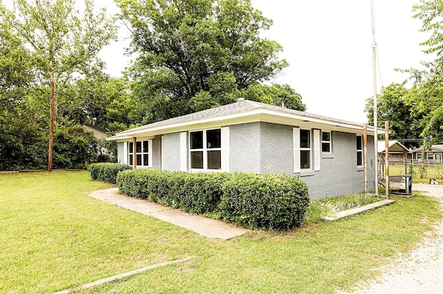 190 Trail Dr, Bowie, TX 76230 - view of side of property featuring brick siding and a yard