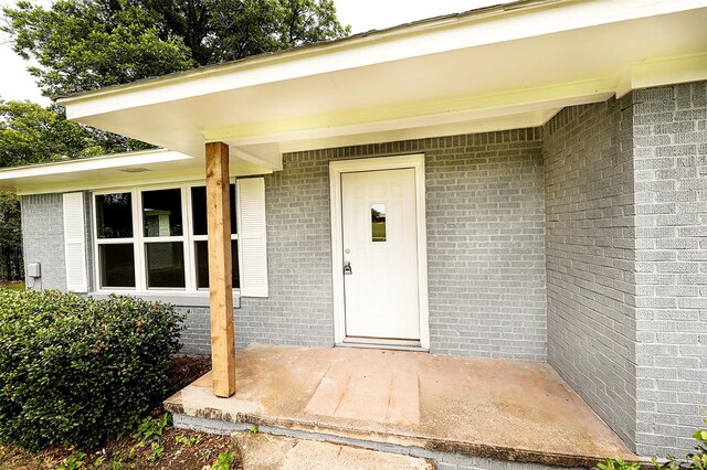 190 Trail Dr, Bowie, TX 76230 - view of exterior entry with brick siding