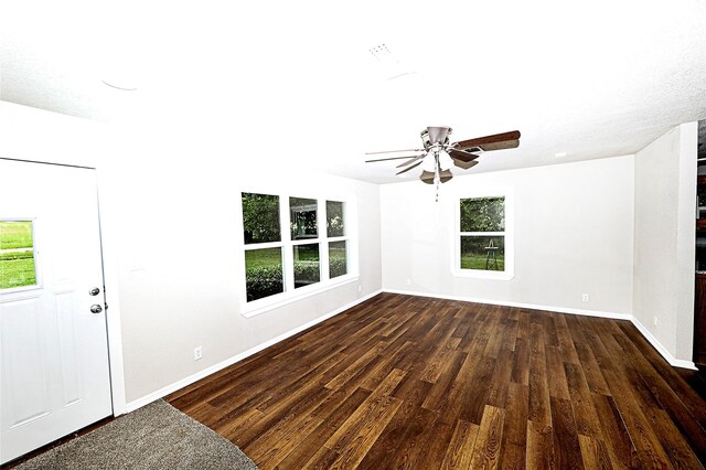 190 Trail Dr, Bowie, TX 76230 - entrance foyer with dark wood finished floors, plenty of natural light, and baseboards