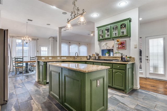 7200 Randall Way, Plano, TX 75025 - kitchen featuring green cabinetry, fridge, a peninsula, stainless steel gas cooktop, and a center island