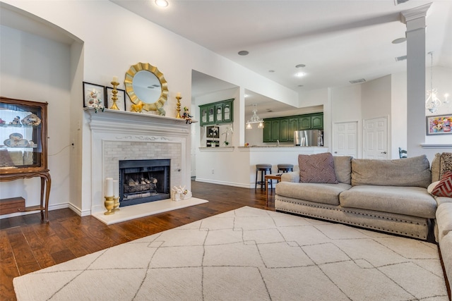 7200 Randall Way, Plano, TX 75025 - living area with dark wood-style flooring, a tiled fireplace, recessed lighting, and baseboards