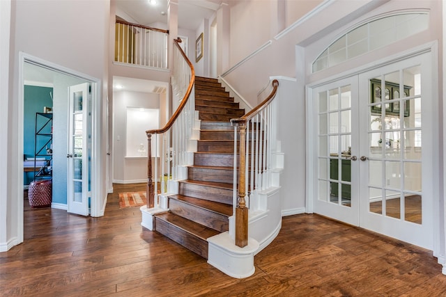 7200 Randall Way, Plano, TX 75025 - staircase with french doors, a towering ceiling, hardwood / wood-style flooring, and baseboards