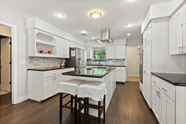 9402 Spring Hollow Dr, Dallas, TX 75243 - kitchen with dark wood-style floors, dark countertops, white cabinetry, and recessed lighting