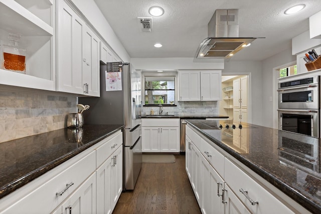 9402 Spring Hollow Dr, Dallas, TX 75243 - kitchen featuring double oven, white cabinets, dark wood-style floors, open shelves, and backsplash