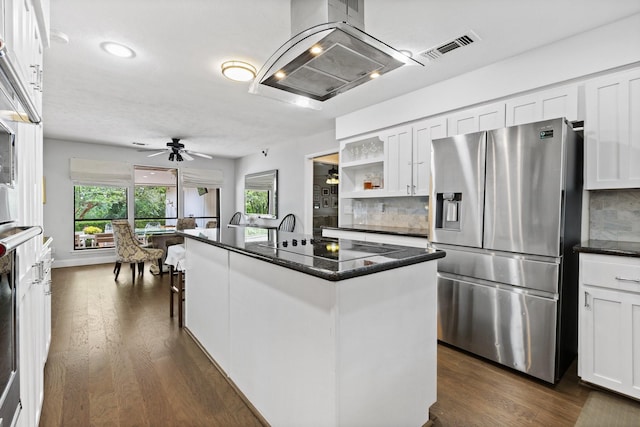 9402 Spring Hollow Dr, Dallas, TX 75243 - kitchen featuring stainless steel fridge with ice dispenser, island exhaust hood, decorative backsplash, white cabinets, and recessed lighting