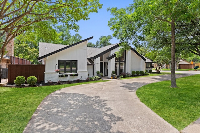 9402 Spring Hollow Dr, Dallas, TX 75243 - view of front of house with brick siding, a shingled roof, and curved driveway