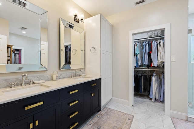 9402 Spring Hollow Dr, Dallas, TX 75243 - full bath with double vanity, a spacious closet, marble look tiles, baseboards, and a stall shower