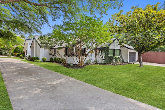 9402 Spring Hollow Dr, Dallas, TX 75243 - view of front facade with a garage, driveway, and brick siding