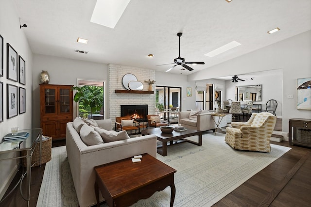 9402 Spring Hollow Dr, Dallas, TX 75243 - living room with a skylight, a ceiling fan, a fireplace, wood finished floors, and vaulted ceiling