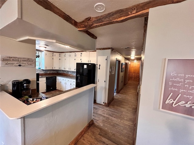 155 Saint Andrews Rd, Amarillo, TX 79118 - kitchen with beam ceiling, wood finished floors, black appliances, white cabinetry, and a textured ceiling