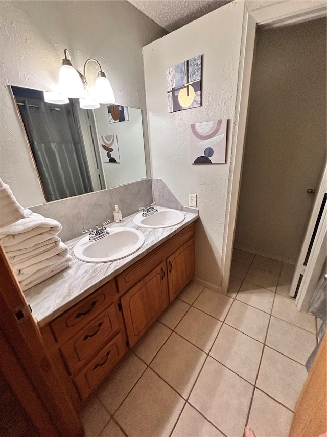 155 Saint Andrews Rd, Amarillo, TX 79118 - bathroom featuring a textured wall, tile patterned flooring, double vanity, and a textured ceiling