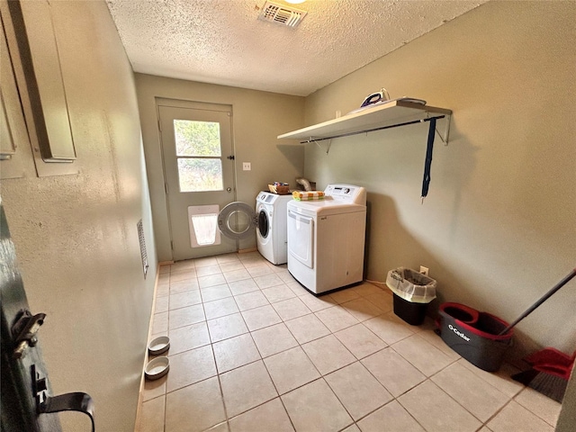 155 Saint Andrews Rd, Amarillo, TX 79118 - laundry room with washer and dryer, light tile patterned flooring, and a textured ceiling