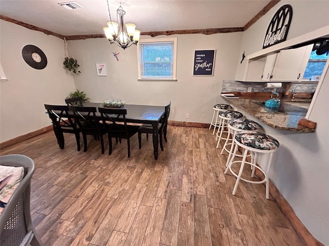 155 Saint Andrews Rd, Amarillo, TX 79118 - dining space featuring ornamental molding, wood finished floors, baseboards, and a chandelier