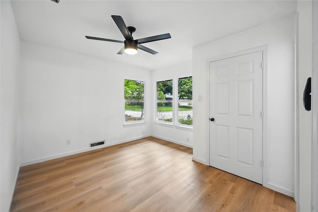 512 Shadowbrook Ln, Hurst, TX 76053 - unfurnished bedroom featuring light wood-style floors, baseboards, and a ceiling fan