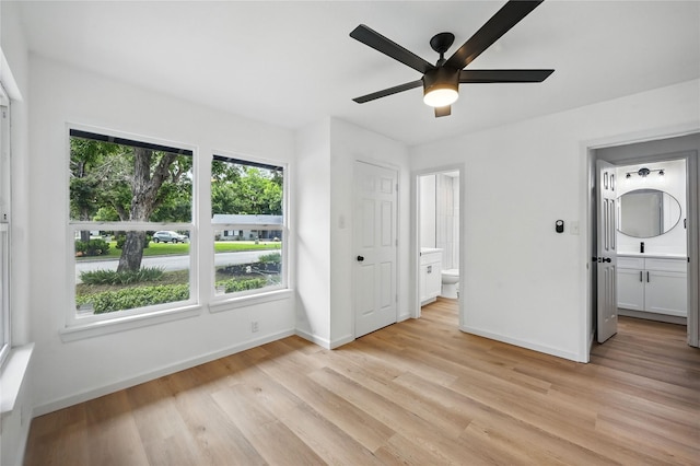 512 Shadowbrook Ln, Hurst, TX 76053 - unfurnished bedroom with baseboards, light wood finished floors, and ensuite bathroom