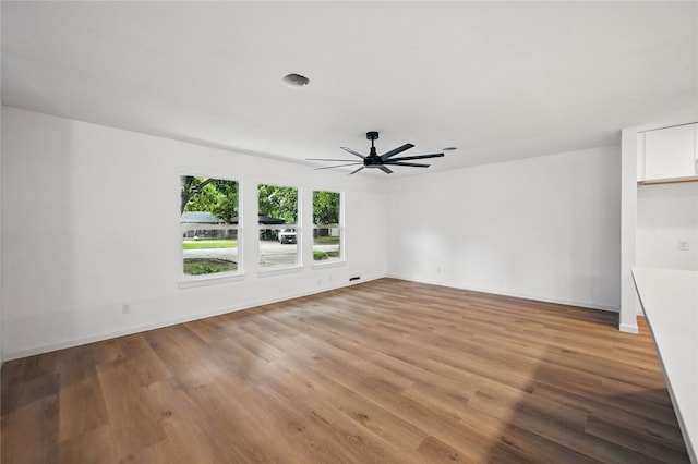 512 Shadowbrook Ln, Hurst, TX 76053 - empty room with a ceiling fan, light wood finished floors, and baseboards