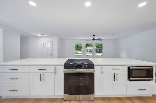 512 Shadowbrook Ln, Hurst, TX 76053 - kitchen featuring black range with gas cooktop, built in microwave, a ceiling fan, white cabinetry, and recessed lighting