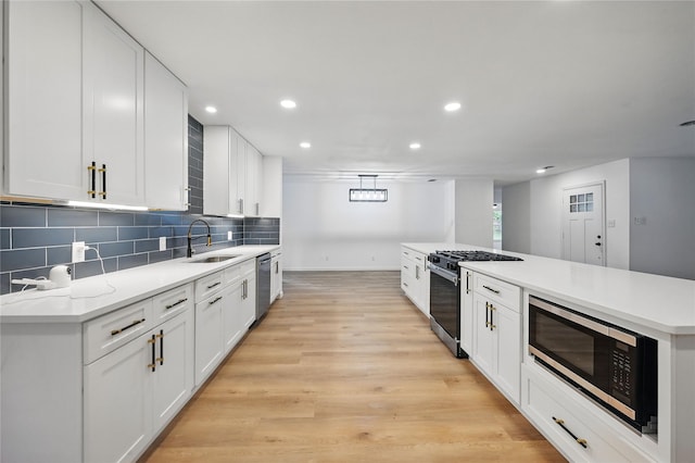 512 Shadowbrook Ln, Hurst, TX 76053 - kitchen featuring stainless steel appliances, a sink, recessed lighting, white cabinetry, and backsplash