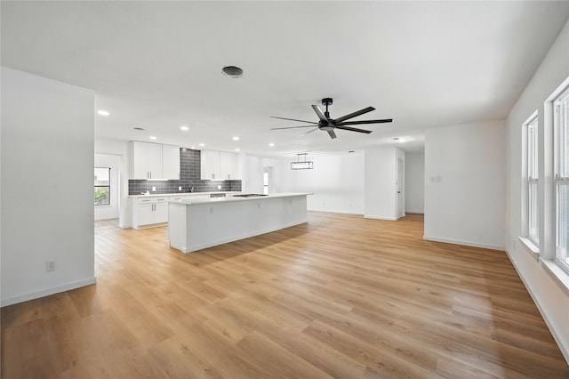 512 Shadowbrook Ln, Hurst, TX 76053 - kitchen featuring a kitchen island, a ceiling fan, white cabinets, recessed lighting, and light countertops