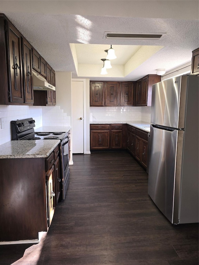 7008 Windhaven Rd, North Richland Hills, TX 76182 - kitchen with freestanding refrigerator, under cabinet range hood, black range with electric stovetop, a raised ceiling, and dark brown cabinets
