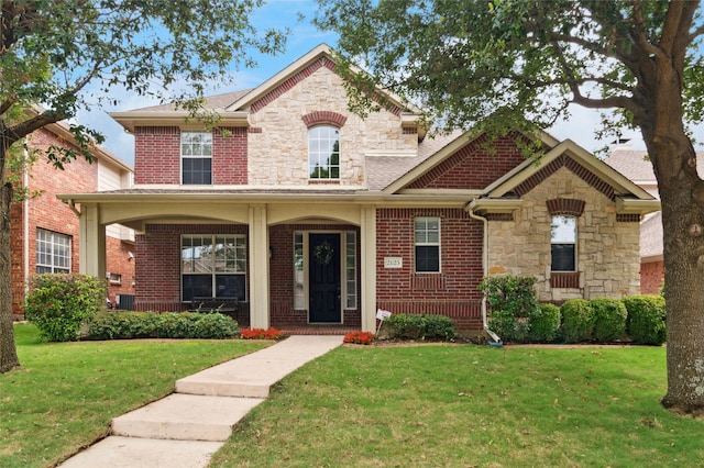 2125 Garden Crest Dr, Rockwall, TX 75087 - view of front of property with stone siding, covered porch, a front lawn, brick siding, and roof with shingles
