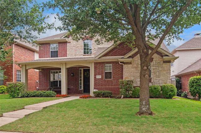 2125 Garden Crest Dr, Rockwall, TX 75087 - view of front facade with a front yard, stone siding, and brick siding