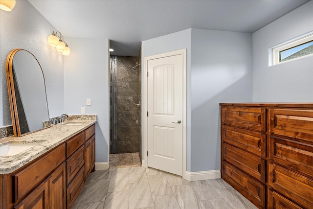 2615 San Gabriel Dr, Granbury, TX 76048 - full bathroom with baseboards, marble look tiles, double vanity, and a tile shower