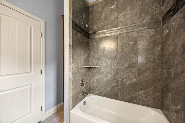 2615 San Gabriel Dr, Granbury, TX 76048 - full bath featuring tub / shower combination, wood finished floors, and baseboards