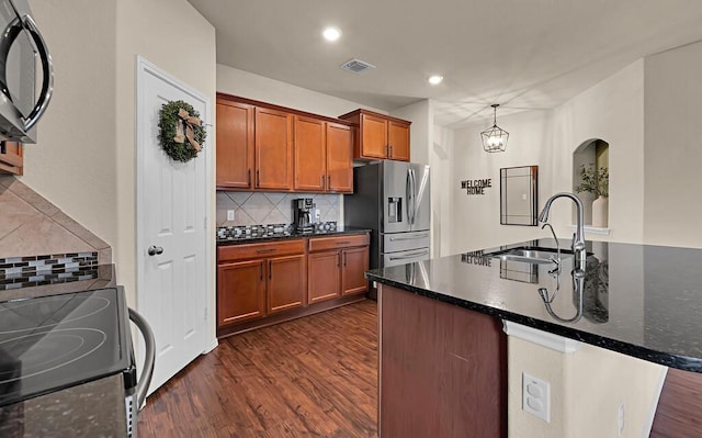 3200 Keathley Dr, Waco, TX 76655 - kitchen featuring stainless steel fridge, range with electric cooktop, dark wood finished floors, a sink, and decorative backsplash