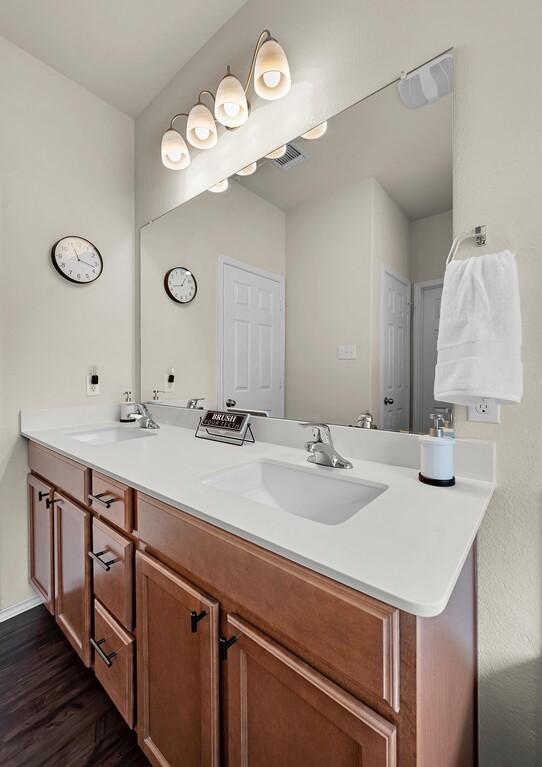 3200 Keathley Dr, Waco, TX 76655 - full bathroom featuring double vanity and wood finished floors