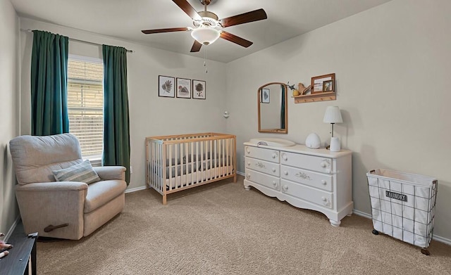 3200 Keathley Dr, Waco, TX 76655 - bedroom with a crib, light colored carpet, baseboards, and ceiling fan
