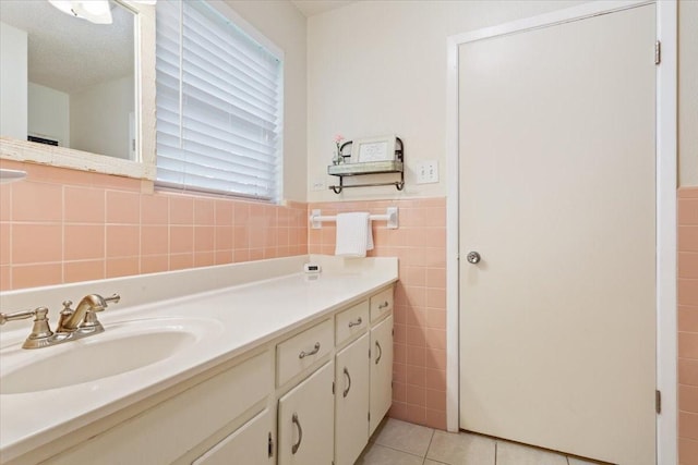 7844 Fairway Rd, Woodway, TX 76712 - bathroom featuring tile walls, vanity, tile patterned flooring, and wainscoting