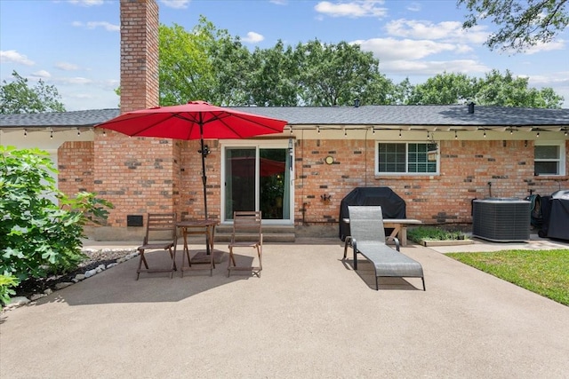 7844 Fairway Rd, Woodway, TX 76712 - back of property featuring central AC, a patio, a chimney, brick siding, and a shingled roof
