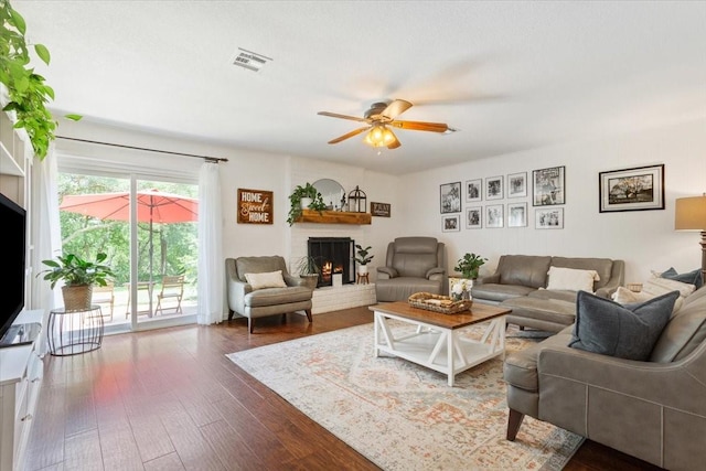 7844 Fairway Rd, Woodway, TX 76712 - living area featuring a fireplace, wood-type flooring, and a ceiling fan