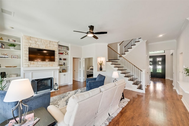 2403 Legend Dr, Heath, TX 75032 - living area featuring stairway, wood finished floors, a fireplace with flush hearth, crown molding, and ceiling fan