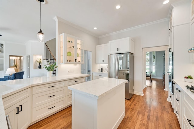 2403 Legend Dr, Heath, TX 75032 - kitchen featuring ornamental molding, glass insert cabinets, white cabinets, light wood finished floors, and pendant lighting