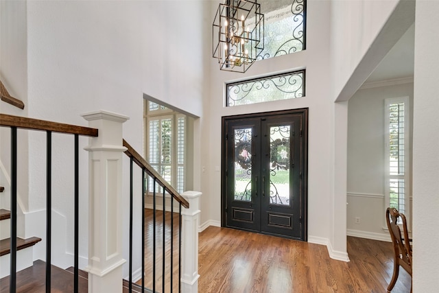 2403 Legend Dr, Heath, TX 75032 - entryway with a chandelier, stairway, wood finished floors, ornamental molding, and baseboards