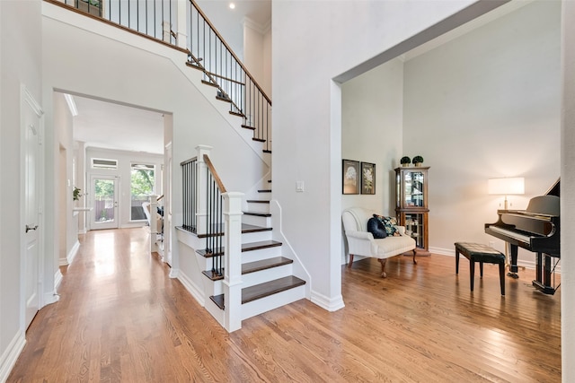 2403 Legend Dr, Heath, TX 75032 - foyer featuring a towering ceiling, light wood-type flooring, stairs, and baseboards