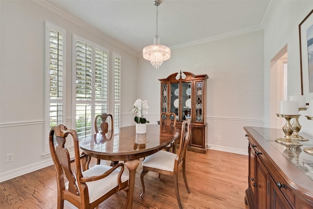 2403 Legend Dr, Heath, TX 75032 - dining area with light wood-style floors, a chandelier, ornamental molding, and baseboards