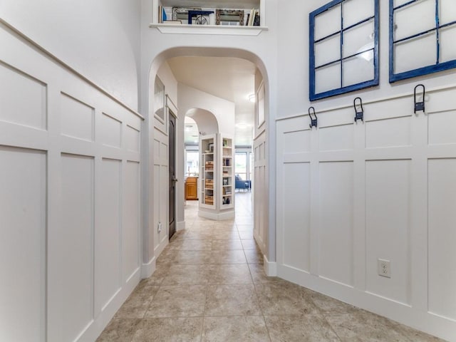 3033 Maple Creek Dr, Fort Worth, TX 76177 - hallway featuring a decorative wall, arched walkways, and light tile patterned flooring