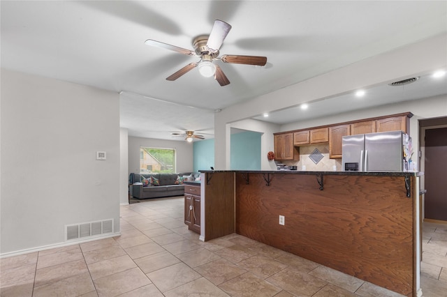 3209 N Calais St, Sherman, TX 75090 - kitchen featuring stainless steel fridge with ice dispenser, ceiling fan, a kitchen bar, open floor plan, and recessed lighting
