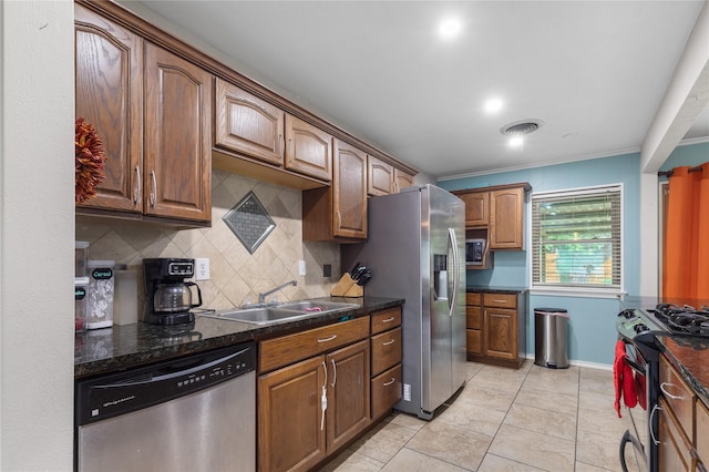 3209 N Calais St, Sherman, TX 75090 - kitchen with stainless steel appliances, a sink, backsplash, ornamental molding, and baseboards