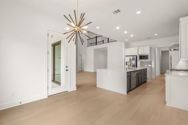 14085 Nicollet Dr, Frisco, TX 75033 - kitchen featuring stainless steel appliances, white cabinetry, a sink, recessed lighting, and extractor fan