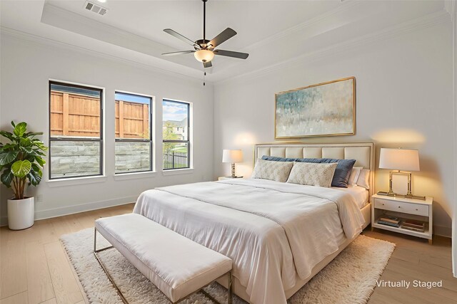14085 Nicollet Dr, Frisco, TX 75033 - bedroom featuring crown molding, a raised ceiling, wood finished floors, baseboards, and a ceiling fan